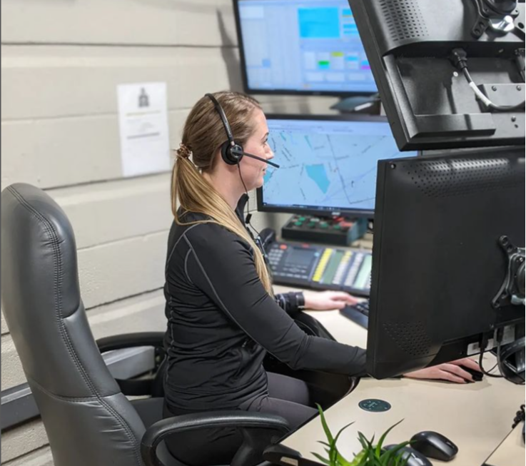 communications dispatcher sitting at their station taking a call